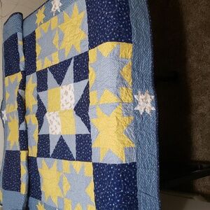 An Amish star baby quilt. 38in x 62in, blue ,yellow and teddy bear fabric